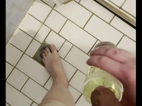 Gay guy drinks pee from a glass in golden shower fetish