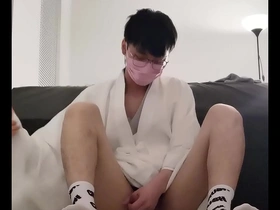 Young Asian boy plays with his body in a rather feminine manner.