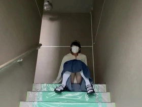 Mayu Konka shows off her pantyhose in a solo photo shoot on the stairs of her apartment.