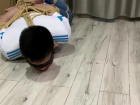 Young Asian man tied up and blindfolded in gay bondage video
